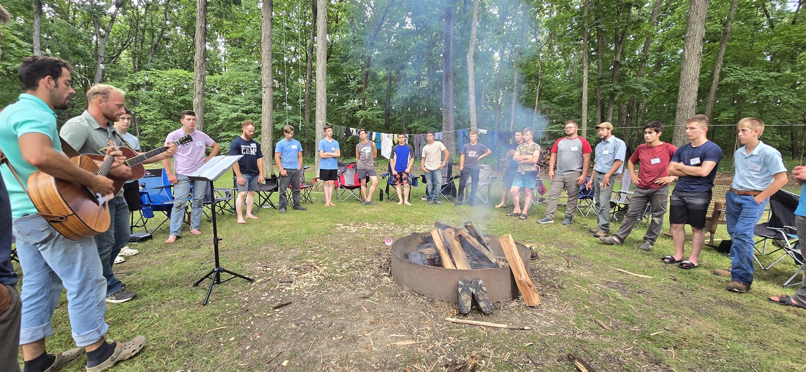 Campers gathered around the campfire for evening worship